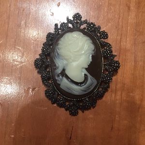 Brown curio brooch